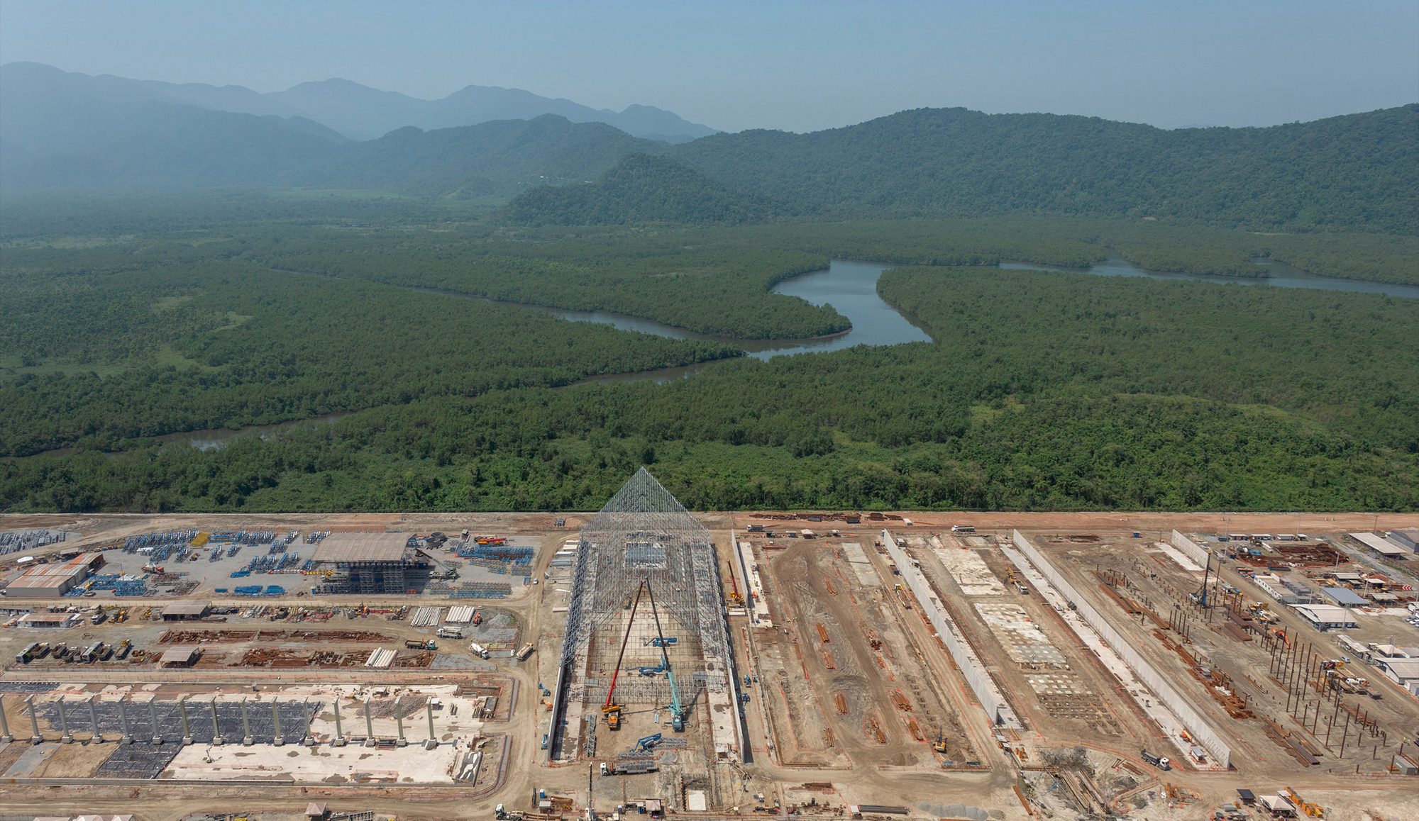 Aerial view of mangrove forest beside a large coastal construction site, Brazil